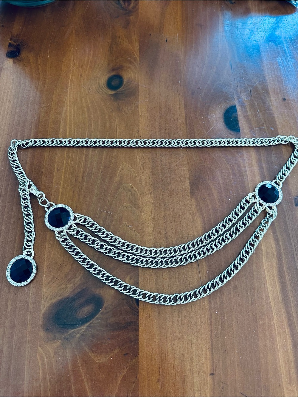 Gold tone triple strand chain belt with black embellishments
